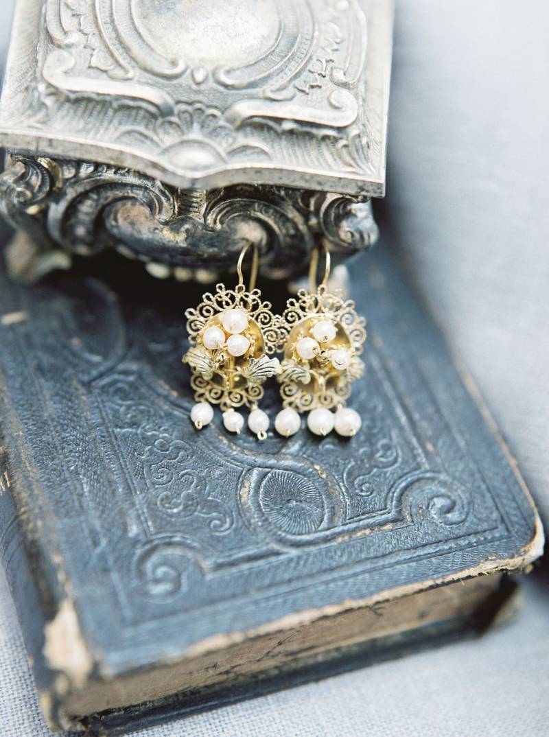 Gold earrings on vintage books
