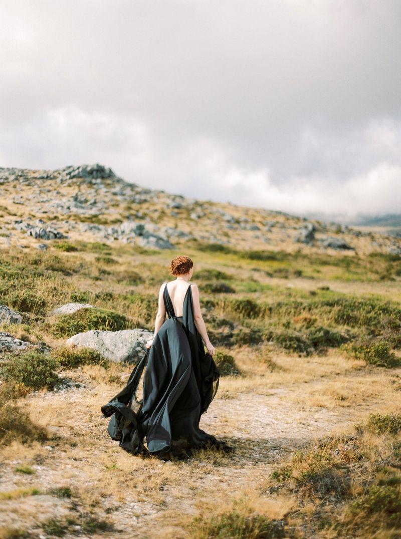 Model in black dress on mountain