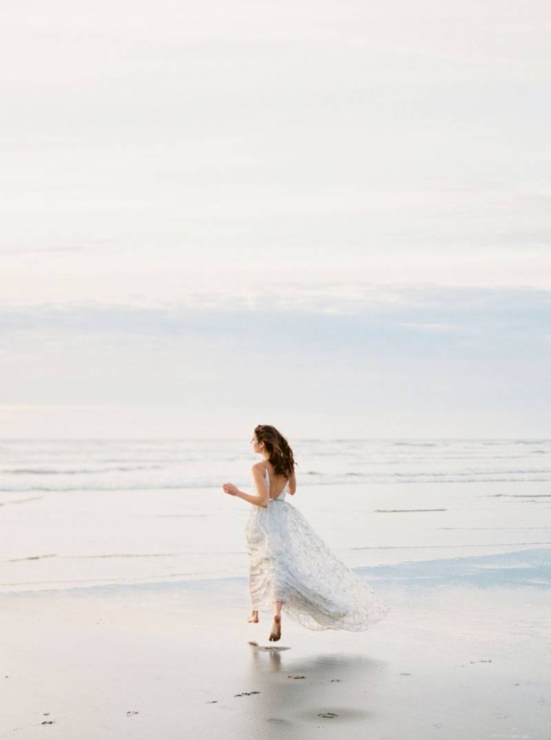 Bride running on beach
