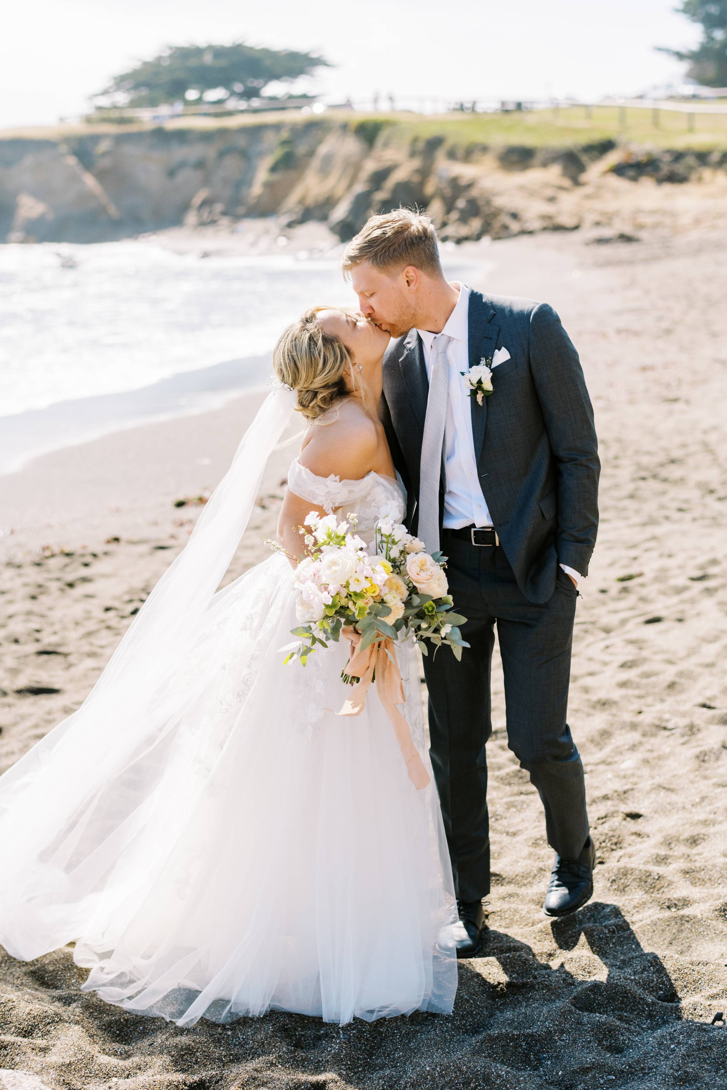 bride, groom, kiss, gown, dress, suit, flowers, bouquet, beach