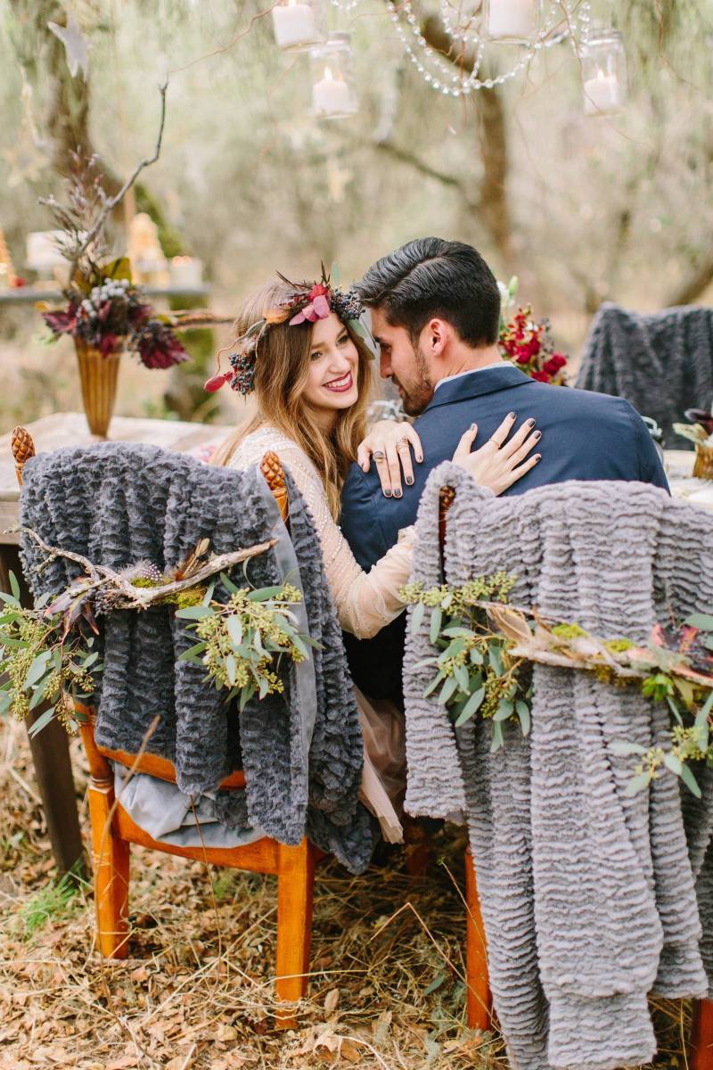 The Couple Sitting on a Chair Giving Pose for their Photoshoot | The Wedding Standard