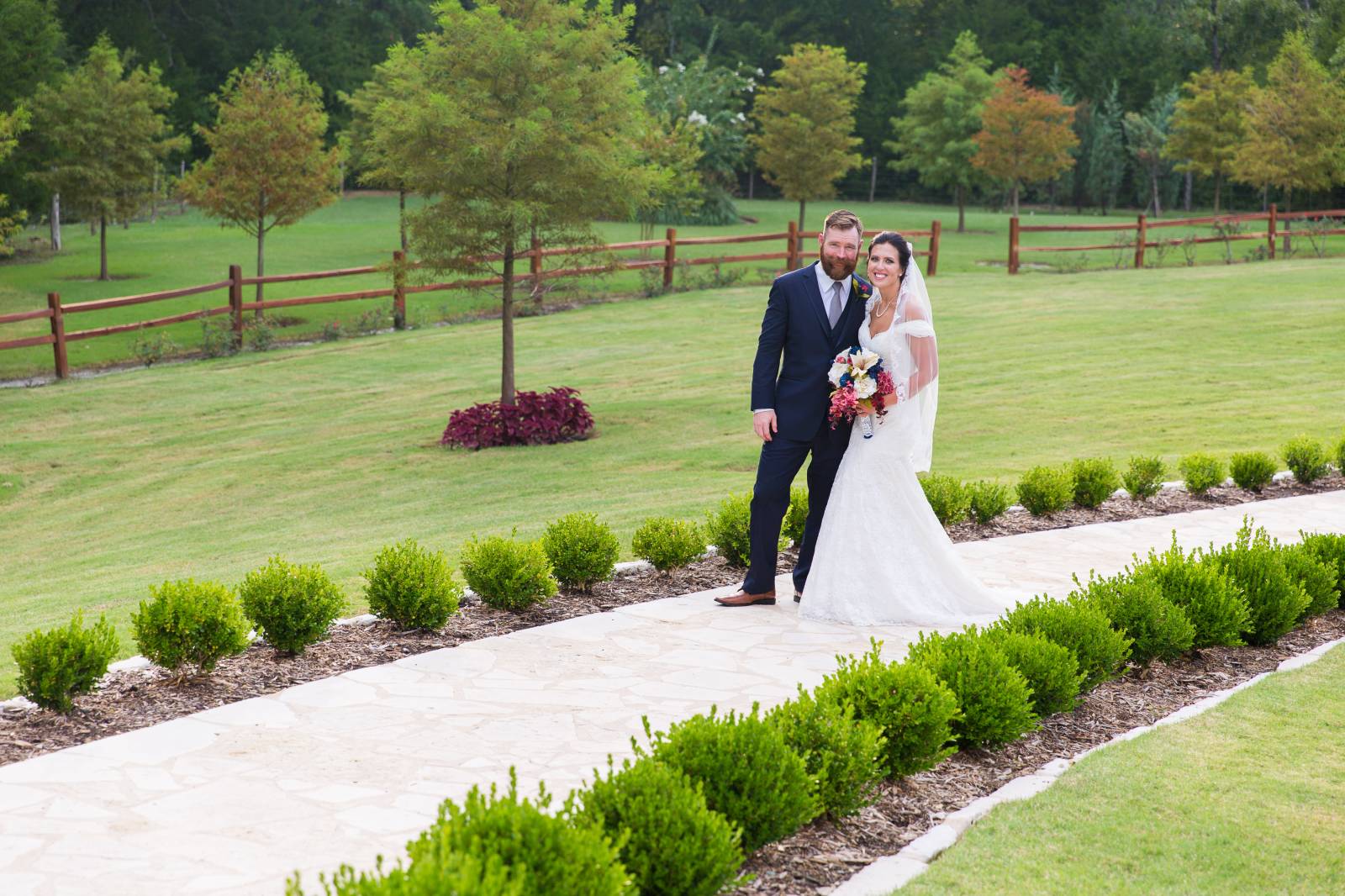 Bride and groom in lush green fields
