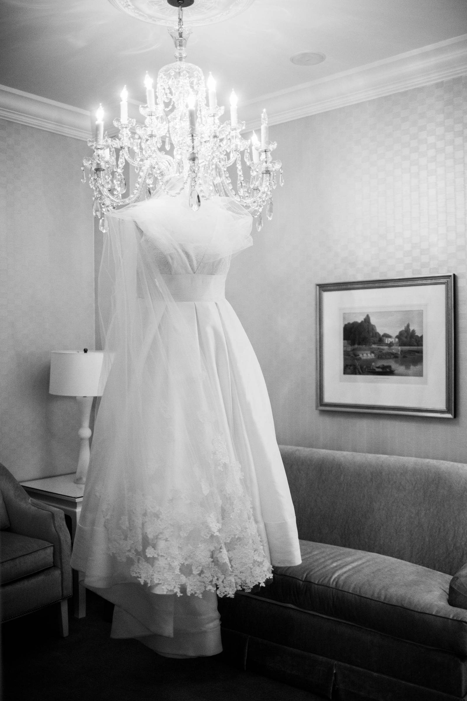 Wedding dress hanging on chandelier