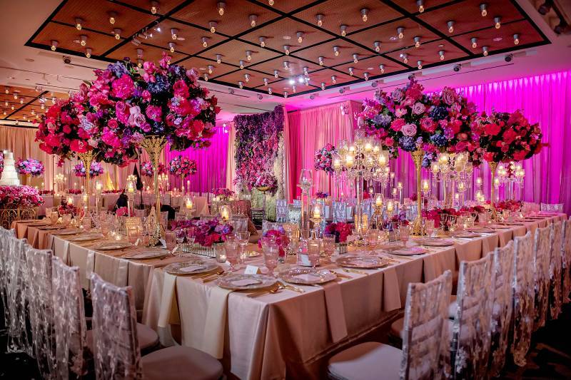 Purple, pink, and gold wedding reception set up