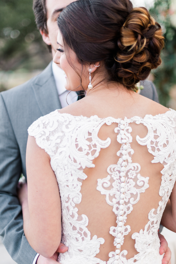 Bridal hair updo & lace wedding dress back