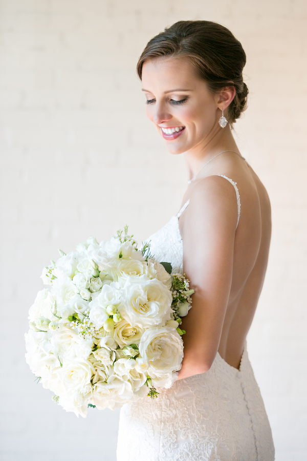 Beautiful bride and all white wedding bouquet