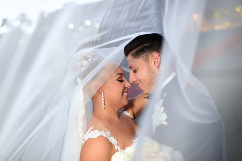 Bride and groom under veil