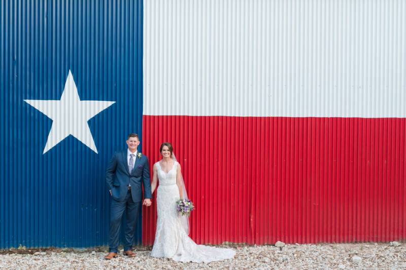 Bride and groom against Texas flag
