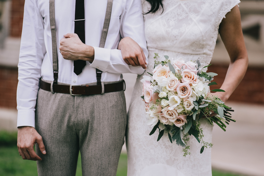 Unique bride and groom shot with bridal bouquet