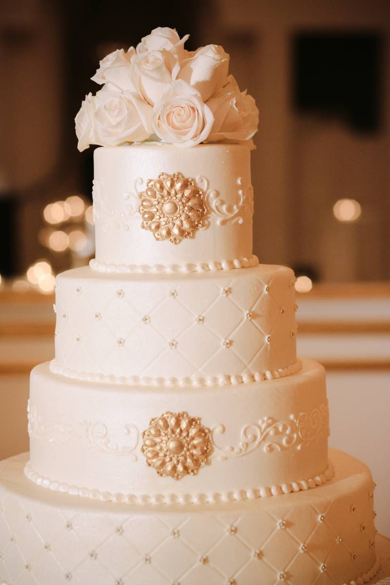 white wedding cake with gold accents