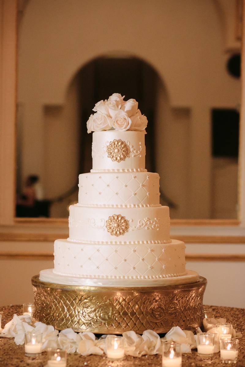 white wedding cake with gold accents