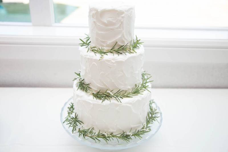 white wedding cake with green accents