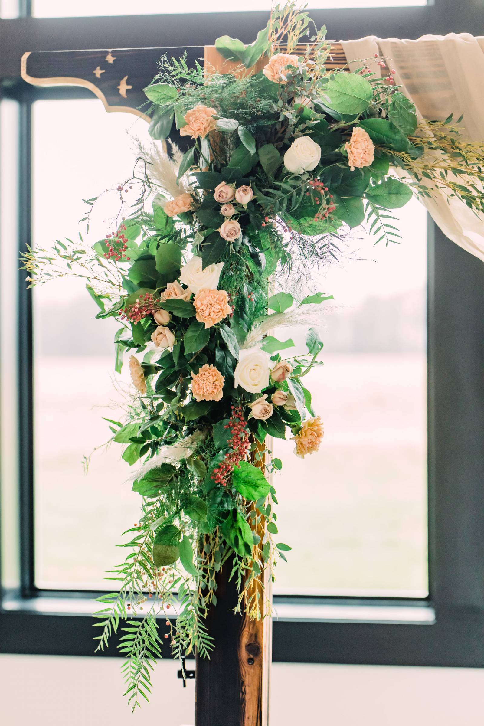 a floral installations on a ceremony arch