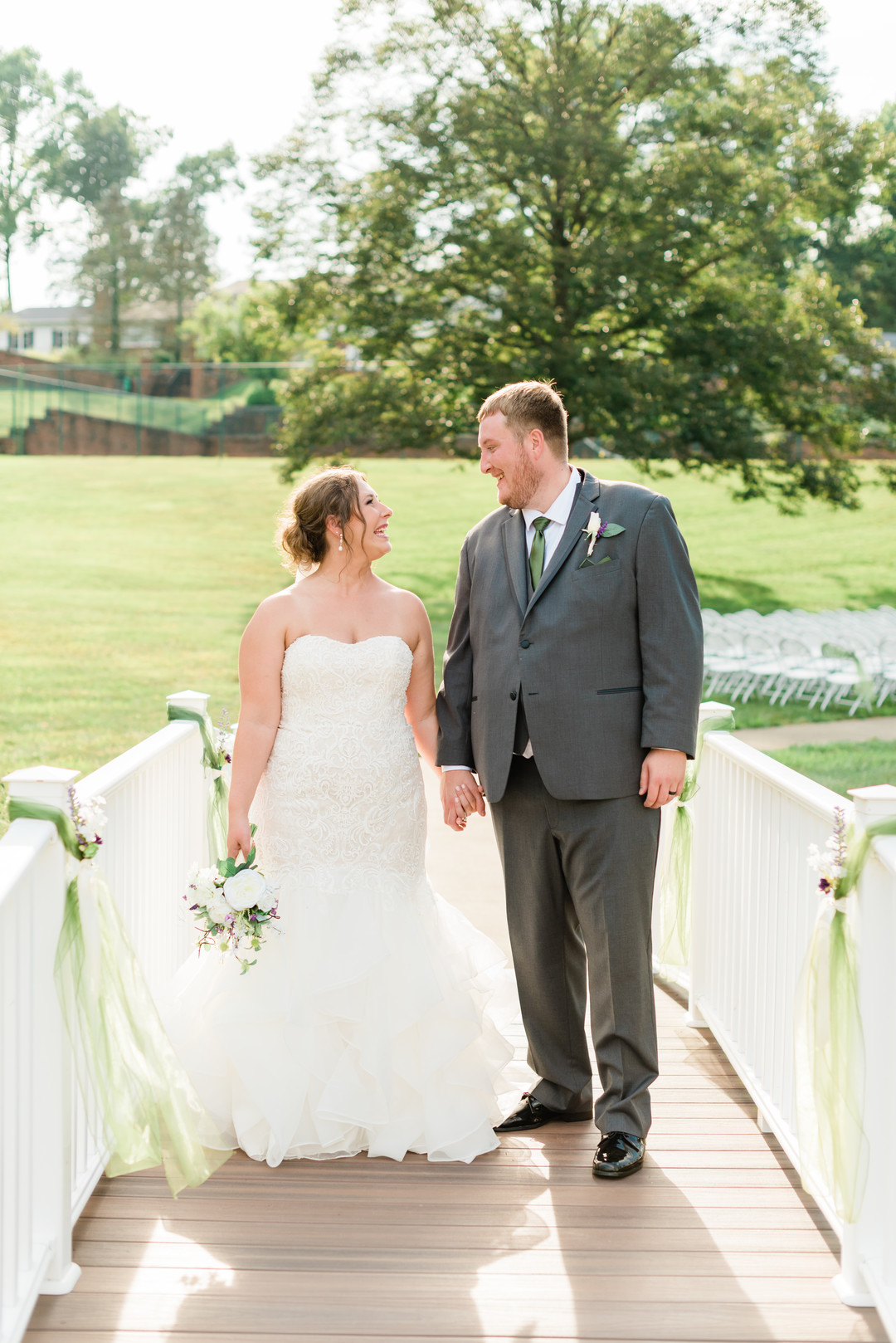 a bride and groom on a white bridge
