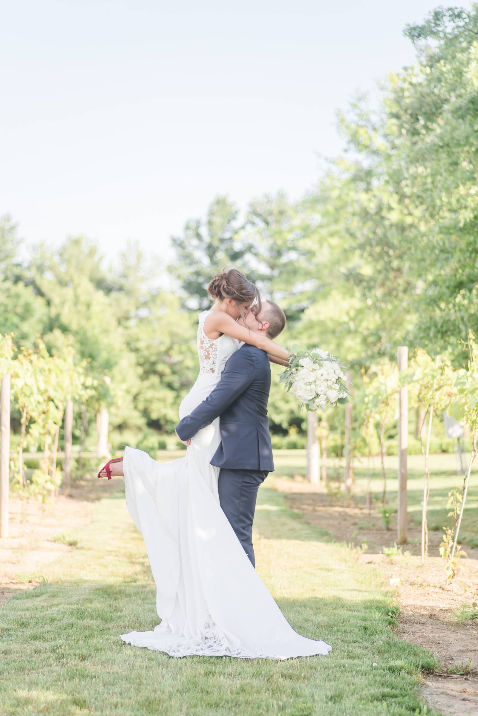 lifted kisses on a vineyard wedding day