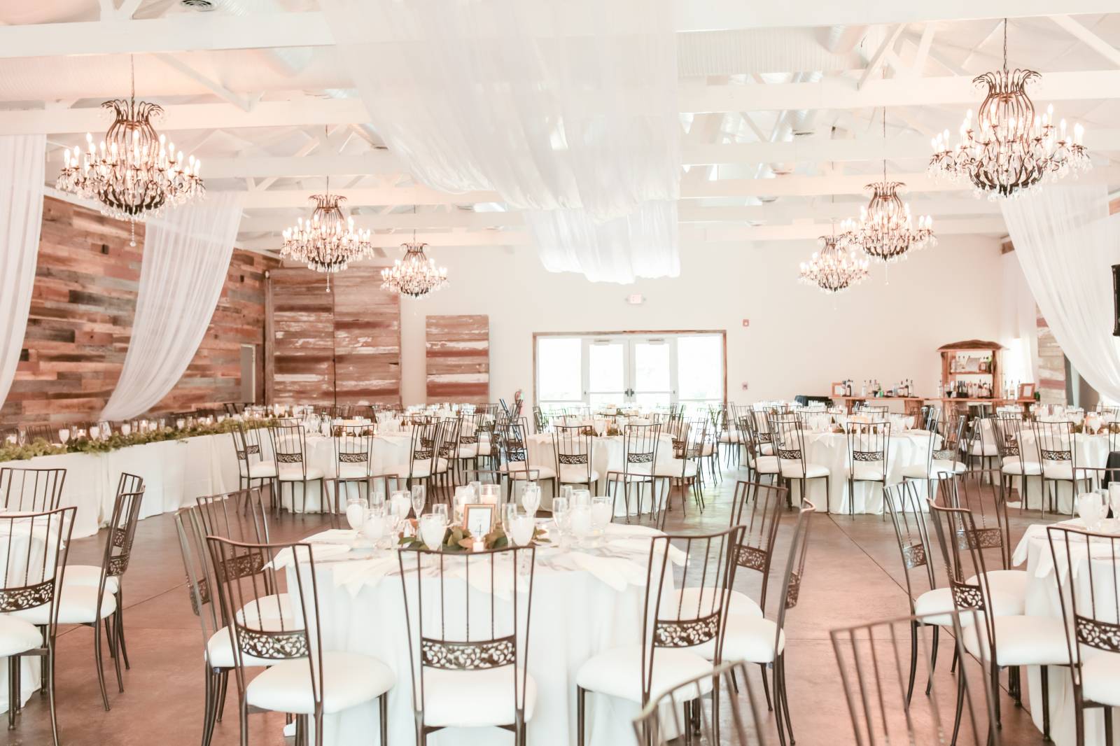 gorgeous ballroom with drapery and black metal chairs